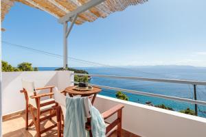 a balcony with a table and chairs and the ocean at Kalithea Studios in Stafylos