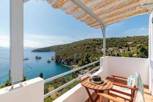 a balcony with a view of the ocean at Kalithea Studios in Stafylos