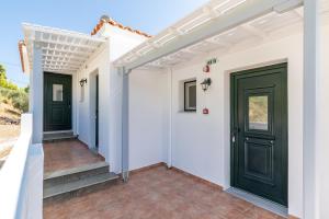 a hallway of a house with green doors at Kalithea Studios in Stafylos