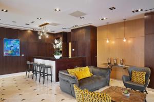 a living room with a couch and a bar at Eurostars Monumental in Barcelona