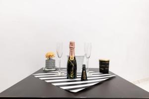 a black table with a bottle of wine and glasses at B&B DEL CORSO in Bari