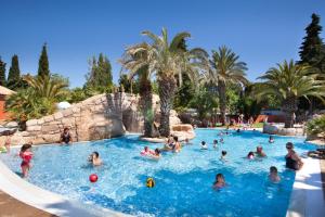 a group of people in a pool at a resort at Mobile Homes by KelAir at Camping L'Hippocampe in Argelès-sur-Mer