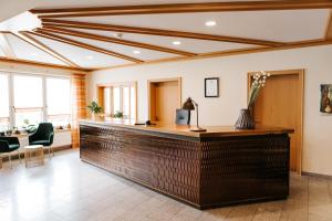 an office lobby with a wooden reception counter at Gasthof Buglhof in Sankt Englmar