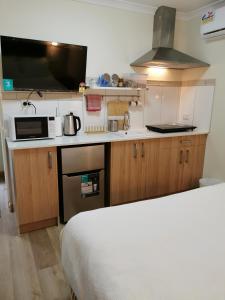 a small kitchen with a bed and a microwave at BHA Unit 6 in Perth