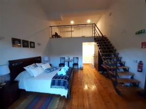 a bedroom with a bed and a staircase in it at Theoxenia in Kalopanayiotis