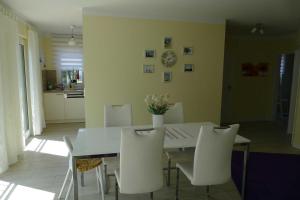 a dining room with a white table and white chairs at Stadtvilla Sommerfrische in Ostseebad Sellin