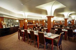 a large dining room with tables and chairs at Harmony Club Hotel in Špindlerův Mlýn