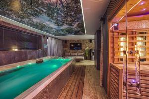 a hot tub in a room with a ceiling at Apartmány Lacov Dom in Klčov