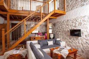 a living room with a couch and a staircase at Exclusive Boutique Hotel 3 in Fethiye