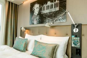 a bed with a picture of a woman on it at Motel One Salzburg-Mirabell in Salzburg