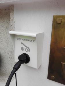 a black cord plugged into a electrical box on a wall at Hotel Villa Kaylaka in Pleven