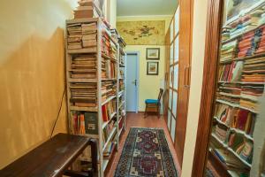 a hallway with book shelves filled with books at Alloggio Turistico Centro Storico Malatesta in Montefiascone