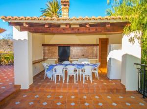 a patio with a table and chairs on a brick floor at Villa Perles - Plusholidays in Calpe