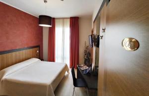 a hotel room with a bed and a window at Hotel Naitendì in Cutrofiano
