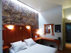a bedroom with a bed and a painting on the wall at Terminus du Forez Saint-Etienne Centre Gare Chateaucreux in Saint-Étienne