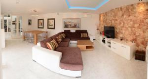 a living room with a couch and a tv at Villa Can Sala in San Antonio Bay