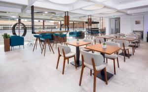 a dining room filled with tables and chairs at The Corner Duomo Hotel in Milan