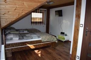 a bedroom with a bed with a wooden ceiling at Zrubový dom - Moon Nová Lesná in Nová Lesná