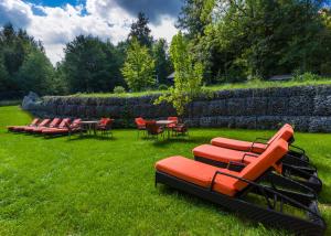 a group of chairs and tables and chairs on the grass at Boutique Hotel Sudetia - Medical & SPA in Świeradów-Zdrój