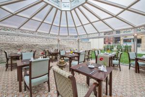 a restaurant with tables and chairs in a domed roof at Enderun Hotel Istanbul in Istanbul