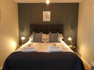 a bedroom with a large bed with two towels on it at Marco Island in Nottingham