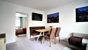 a living room with a table and chairs in a room at central & lovely - for up to 6 persons in Würzburg