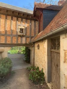 an old building with a bridge over a courtyard at Parc de Lesseps in Meunet-Planches
