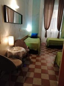 a room with two beds and a desk at Român Holidays in Rome