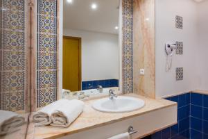 a bathroom with a sink and a mirror at Iberostar Founty Beach in Agadir