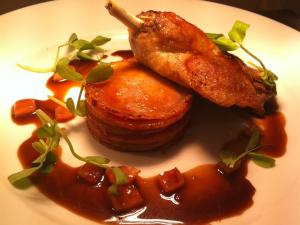 a plate of food with meat and sauce on it at Ye Olde George Inn - Badger Pubs in Privett