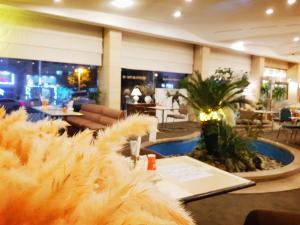 a hotel lobby with a large fur couch and tables at Pearl Hotel Jeju in Jeju