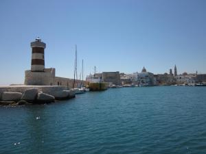 a lighthouse in the middle of a body of water at B&B Al Picchio in Monopoli