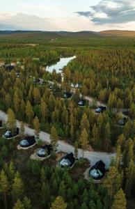 an aerial view of a camp site with tents and a river at Aurora Village Ivalo in Ivalo