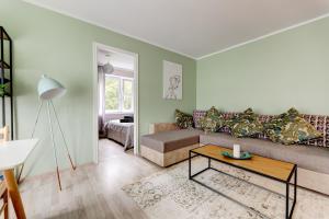 a living room with a couch and a table at Aura, City Center, Tartu Home in Tartu