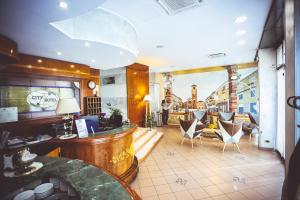 a restaurant with chairs and a bar in a room at Hotel City in Chivasso