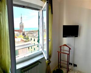 a window in a room with a view of a city at La Casa sui Tetti in Genova