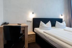 Postel nebo postele na pokoji v ubytování Hotel Fischertor