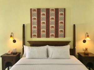a bedroom with a bed with two night stands and two lamps at Ao Nang Colors Hotel - Aonang Beach in Ao Nang Beach +32 photos
