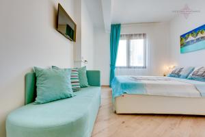 a bedroom with a bed and a couch at Sveti Luka Apartments in Dobra Voda