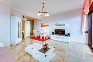 a living room with a table and a dining room at Sveti Luka Apartments in Dobra Voda