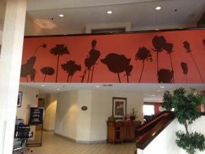 a lobby with a mural of trees on the wall at Sleep Inn Pelham Oak Mountain in Pelham