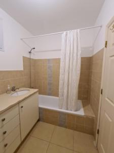 a bathroom with a tub and a sink and a shower at נוף הרים Mountain View in Neve Daniel