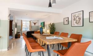 een eetkamer met een houten tafel en stoelen bij The Southwick Sanctuary - Large 6BDR with Terrace in Londen