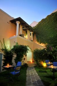 een huis met stoelen en tafels in de tuin bij Hotel La Casa sul Mare in Procida