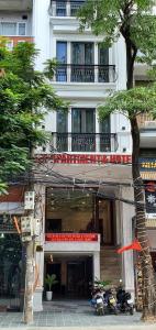 a building with motorcycles parked in front of it at Lee Apartment & Hotel in Hai Phong