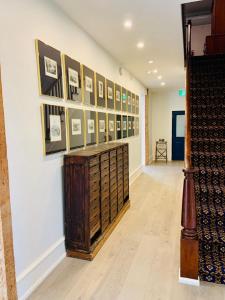 a hallway with a wall of pictures on a wall at South Landing Inn in Niagara on the Lake