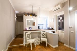 eine Küche mit zwei Hockern und einer Theke in einem Zimmer in der Unterkunft La Maison di Sant'Anna in Rom