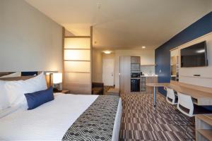 A bed or beds in a room at Microtel Inn & Suites by Wyndham Loveland