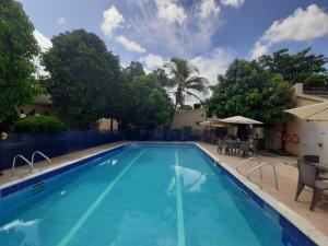 a large swimming pool with blue water in a resort at Condominio El Portal Casa 5 in Carmen de Apicalá