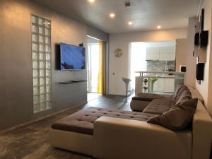 a living room with a couch and a tv at Luxury Westpark 2 Residence Lake View W6 in Bucharest